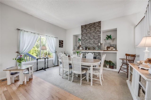 11760 Eudora Ct, Thornton, CO 80233 - dining space featuring light wood-style floors, a textured ceiling, and baseboards
