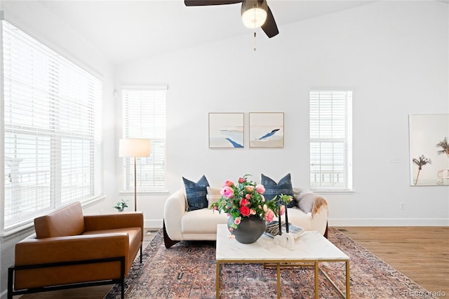 living room with vaulted ceiling, ceiling fan, and hardwood / wood-style flooring