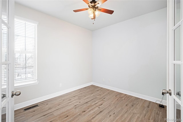 unfurnished room featuring light hardwood / wood-style flooring, ceiling fan, and french doors