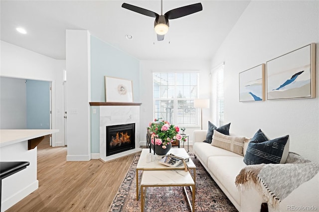 living room featuring light wood finished floors, recessed lighting, a ceiling fan, vaulted ceiling, and a tile fireplace