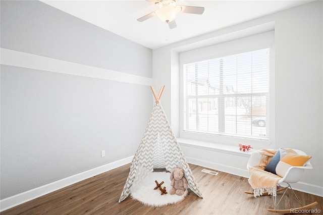 playroom featuring visible vents, baseboards, and wood finished floors