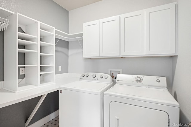 laundry area featuring washer and clothes dryer and cabinet space