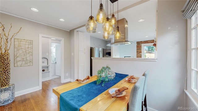 dining space with wood-type flooring and plenty of natural light