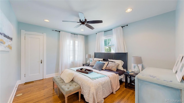 bedroom with light hardwood / wood-style floors and ceiling fan