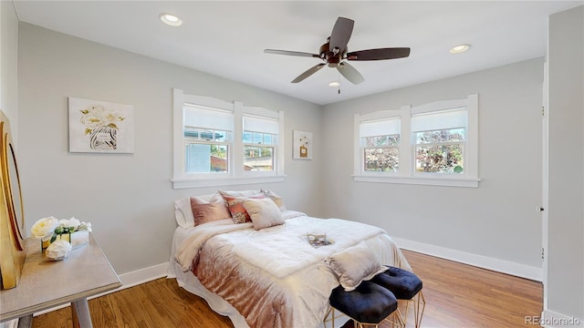 bedroom with ceiling fan and hardwood / wood-style floors