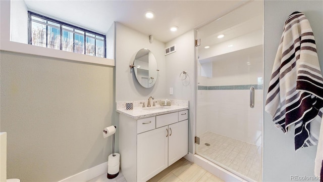 bathroom with vanity and a shower with shower door