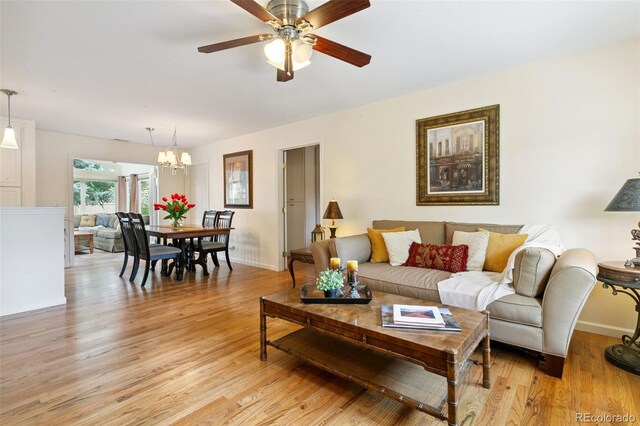 4803 N Weber St, Colorado Springs, CO 80907 - living area featuring light wood-style flooring, a chandelier, and ceiling fan