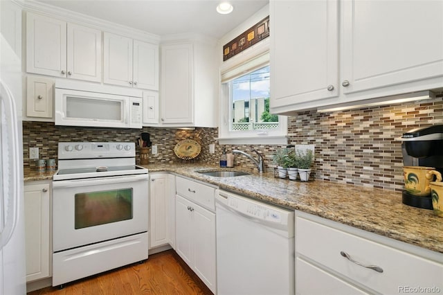 4803 N Weber St, Colorado Springs, CO 80907 - kitchen with white appliances, white cabinets, and decorative backsplash