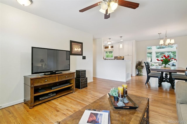 4803 N Weber St, Colorado Springs, CO 80907 - living room featuring ceiling fan, a chandelier, and light wood-type flooring