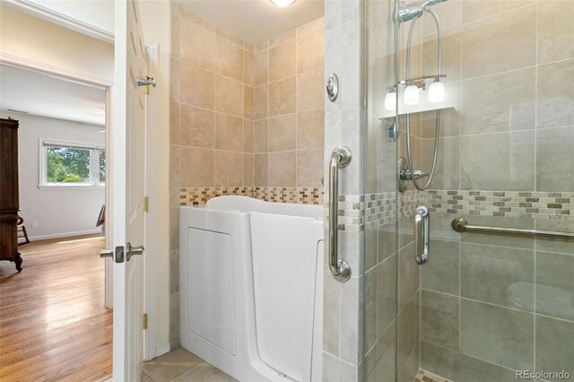 4803 N Weber St, Colorado Springs, CO 80907 - bathroom featuring a shower stall and wood finished floors