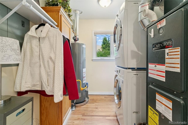 4803 N Weber St, Colorado Springs, CO 80907 - laundry area featuring cabinet space, stacked washer / drying machine, gas water heater, light wood finished floors, and heating unit