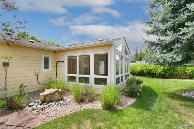 4803 N Weber St, Colorado Springs, CO 80907 - view of side of home with a sunroom and a lawn