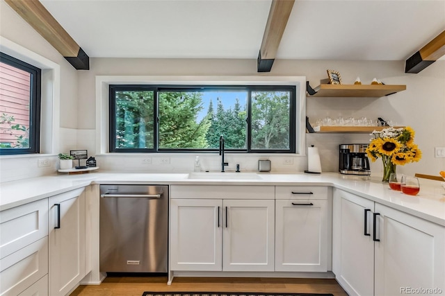 249 E Coyote Ct, Silverthorne, CO 80498 - kitchen with stainless steel dishwasher, beamed ceiling, decorative backsplash, white cabinets, and light countertops