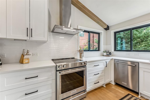 249 E Coyote Ct, Silverthorne, CO 80498 - kitchen with stainless steel appliances, extractor fan, white cabinets, and light countertops