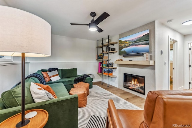 249 E Coyote Ct, Silverthorne, CO 80498 - living area with wood finished floors, a large fireplace, and a ceiling fan