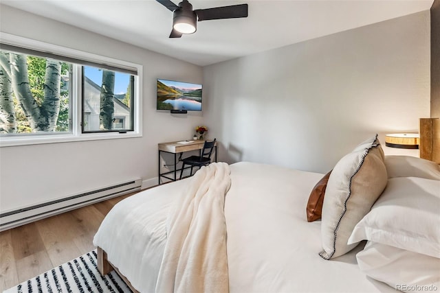 249 E Coyote Ct, Silverthorne, CO 80498 - bedroom with a baseboard radiator, wood finished floors, and a ceiling fan