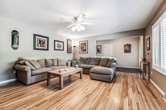 living room featuring ceiling fan, light hardwood / wood-style flooring, and plenty of natural light