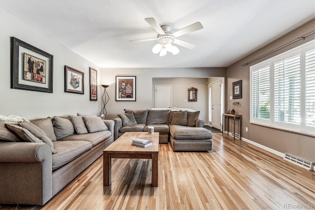 living room featuring light wood-type flooring and ceiling fan