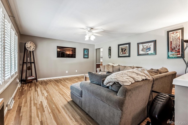 living room featuring ceiling fan and light hardwood / wood-style flooring