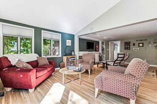 living room with vaulted ceiling and hardwood / wood-style flooring