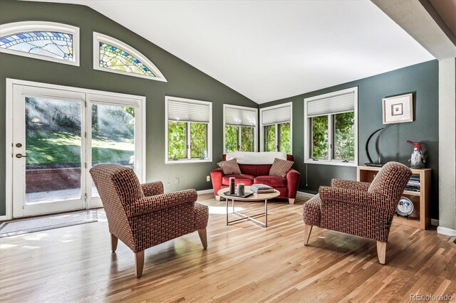 sunroom with plenty of natural light and vaulted ceiling