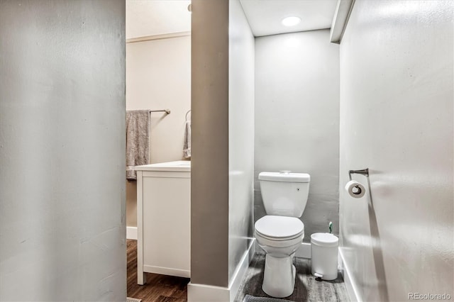 bathroom with hardwood / wood-style flooring and toilet