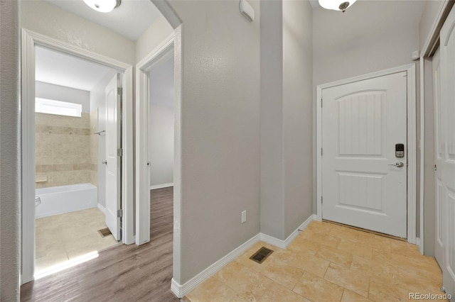 corridor with light hardwood / wood-style flooring