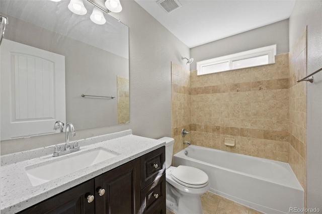 full bathroom featuring tile patterned flooring, vanity, toilet, and tiled shower / bath combo