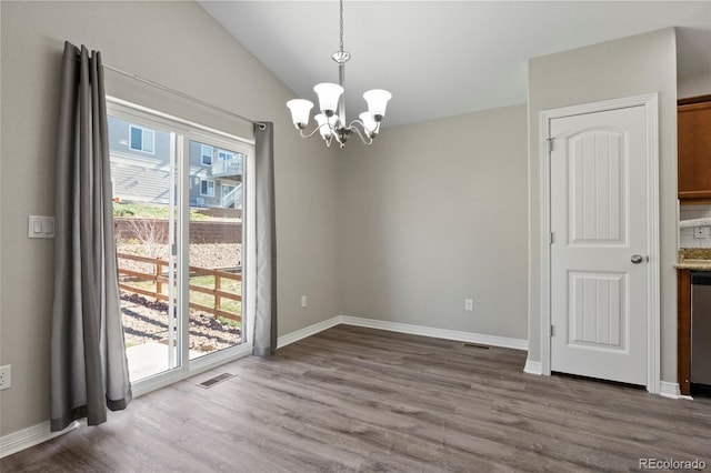 unfurnished dining area with a wealth of natural light, wood-type flooring, and vaulted ceiling