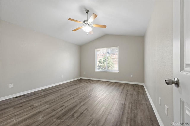 spare room featuring dark wood-type flooring, ceiling fan, and lofted ceiling