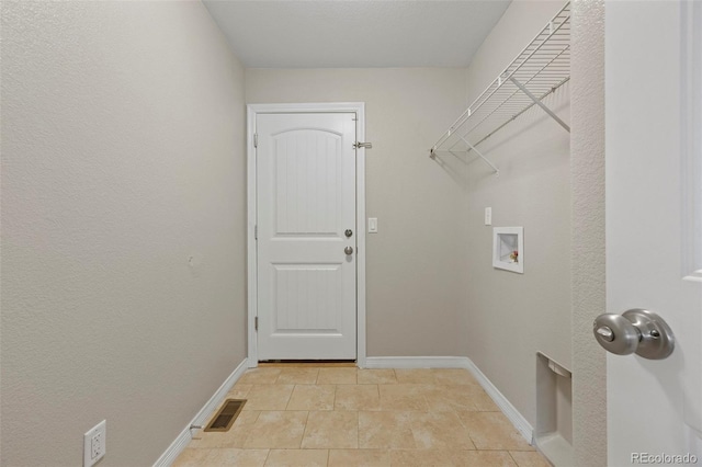 laundry room with hookup for a washing machine and light tile patterned floors