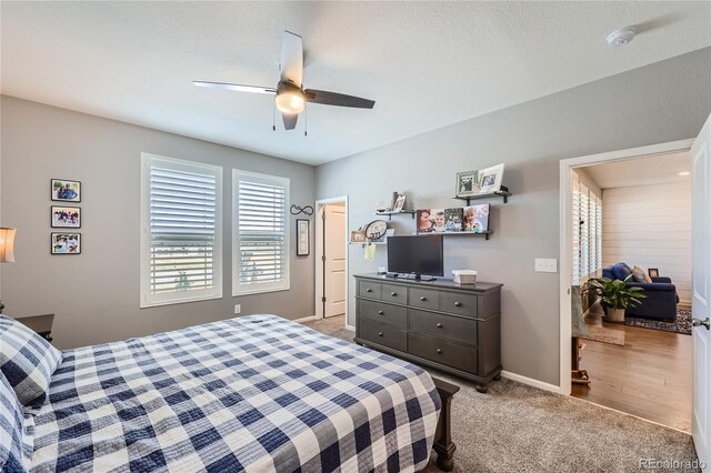 bedroom with ceiling fan and light colored carpet