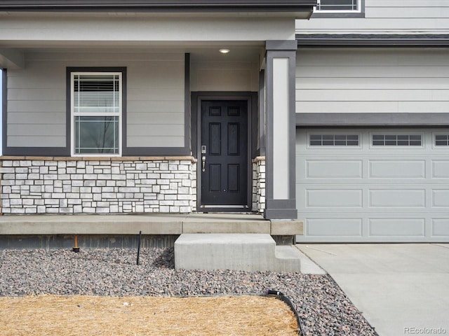 entrance to property featuring a garage and driveway