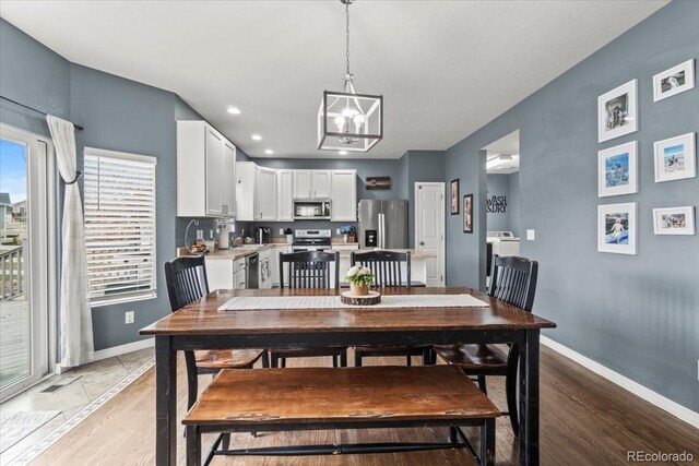 5404 Fawn Ridge Way, Castle Rock, CO 80104 - dining area featuring a chandelier, baseboards, light wood-type flooring, and recessed lighting