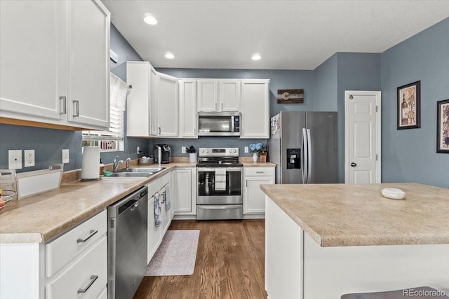 5404 Fawn Ridge Way, Castle Rock, CO 80104 - kitchen with stainless steel appliances, a sink, dark wood-type flooring, white cabinetry, and recessed lighting