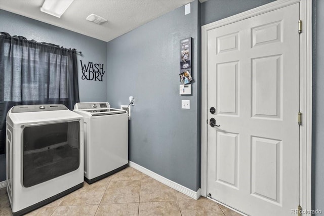 5404 Fawn Ridge Way, Castle Rock, CO 80104 - laundry room with washer and clothes dryer, baseboards, light tile patterned flooring, a textured wall, and a textured ceiling