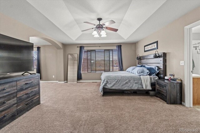 5404 Fawn Ridge Way, Castle Rock, CO 80104 - bedroom featuring carpet flooring, arched walkways, a raised ceiling, and baseboards