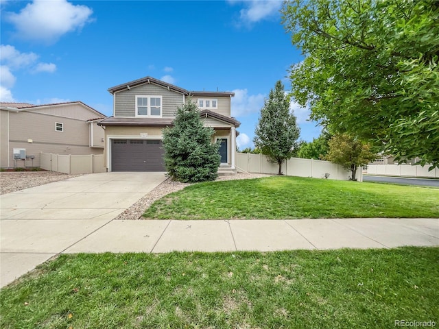 view of front of property featuring a front yard and a garage