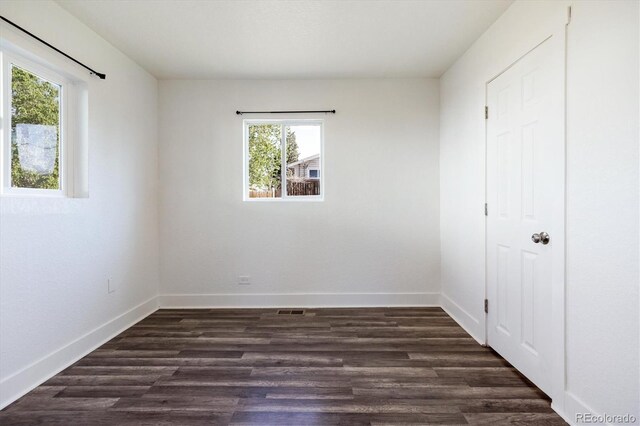 4401 W Mississippi Ave, Denver, CO 80219 - unfurnished bedroom featuring dark wood-type flooring and baseboards