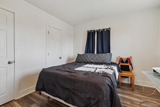 4401 W Mississippi Ave, Denver, CO 80219 - bedroom with baseboards and wood finished floors