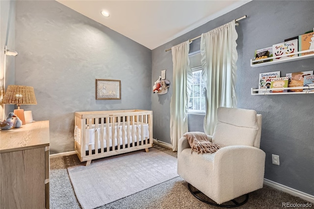 bedroom featuring carpet flooring and a nursery area