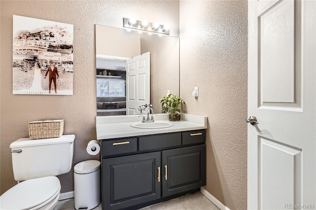 bathroom featuring tile patterned floors, vanity, and toilet