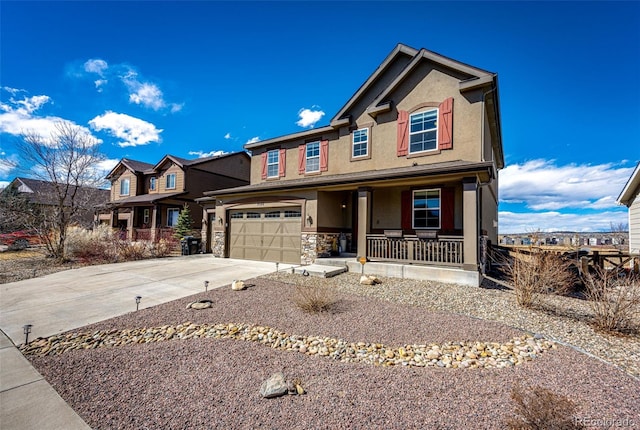 view of front facade featuring stucco siding, covered porch, a garage, stone siding, and driveway