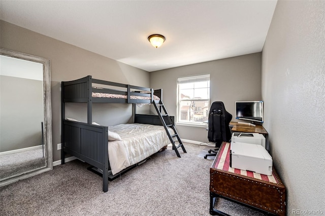 carpeted bedroom featuring baseboards