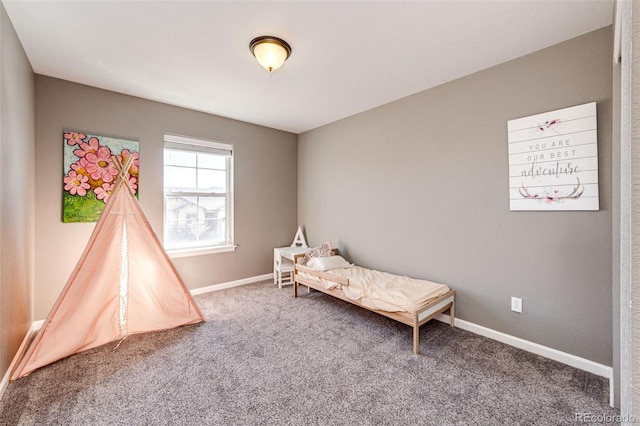 carpeted bedroom featuring baseboards