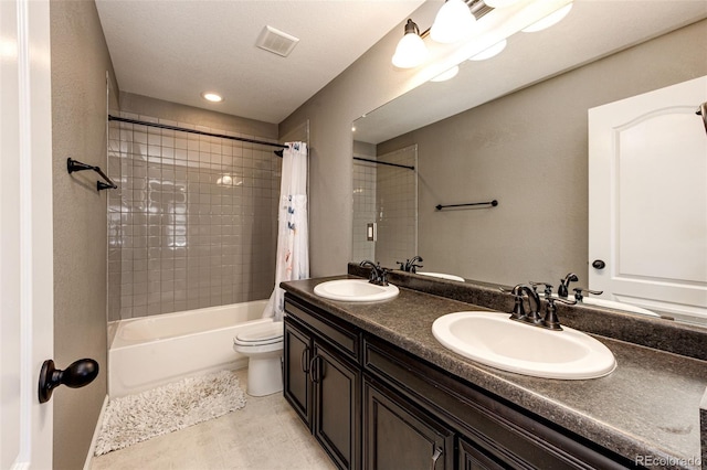 bathroom with toilet, visible vents, a sink, and shower / tub combo with curtain