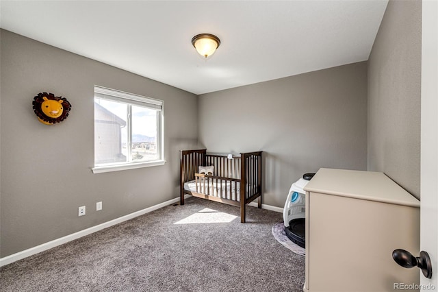 bedroom with carpet floors, white fridge, a crib, and baseboards