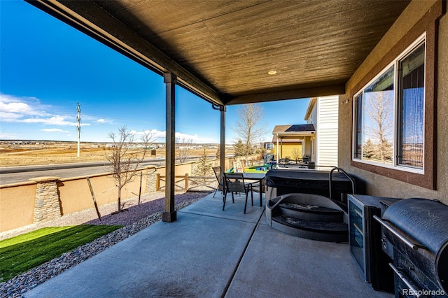 view of patio featuring fence and outdoor dining space