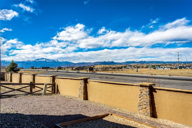 view of yard featuring a mountain view and fence