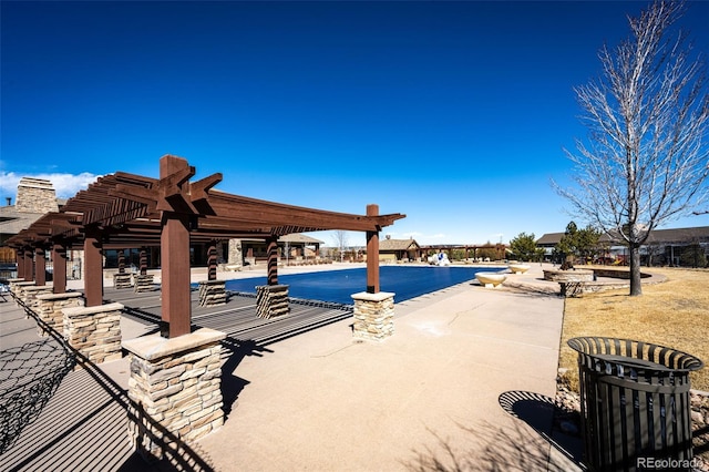 view of pool with a pergola and a patio